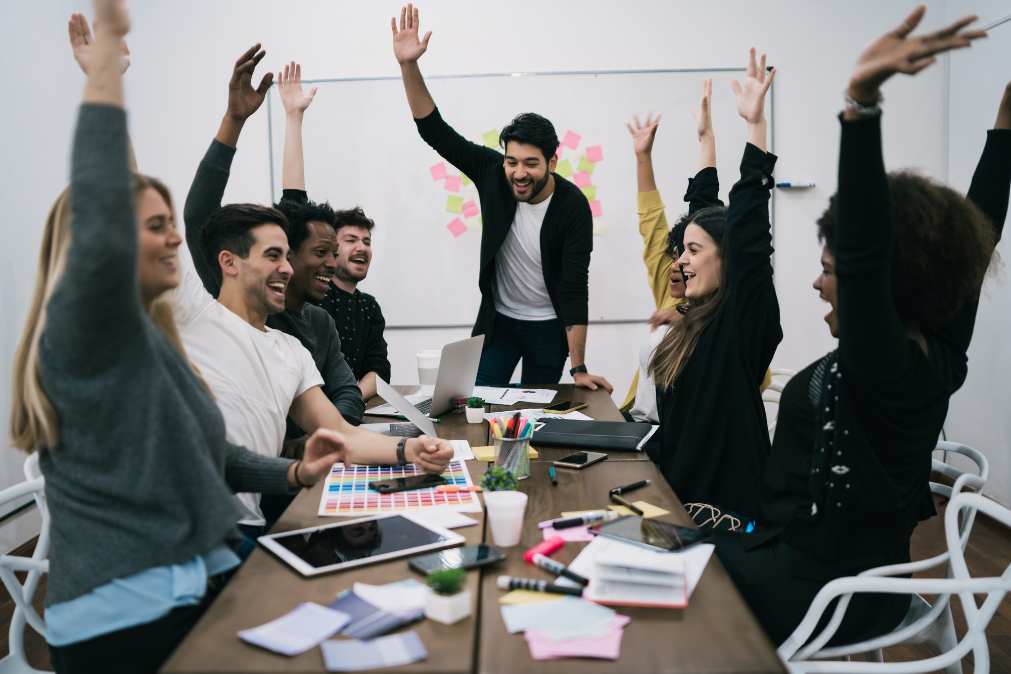 business team celebrating with raised up hands