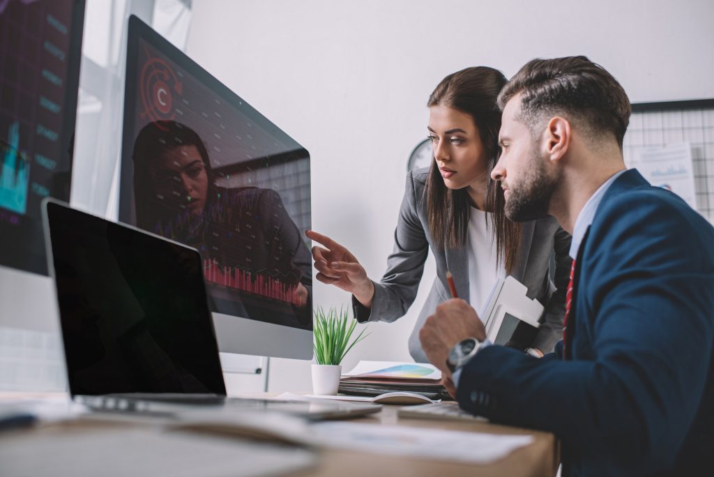 selective focus of information security analysts using charts on computer monitors while working in